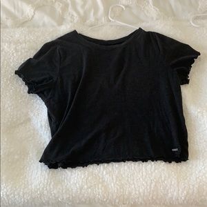 Cute black crop top with ruffled edges.